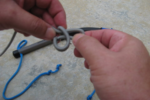 photo of forming a loop with thumb and forefinger for a larks head knot