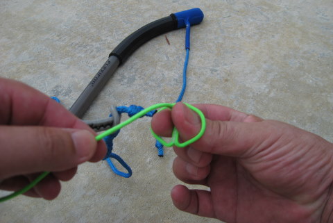 folding the loop over and pinching the line to start a larks head knot